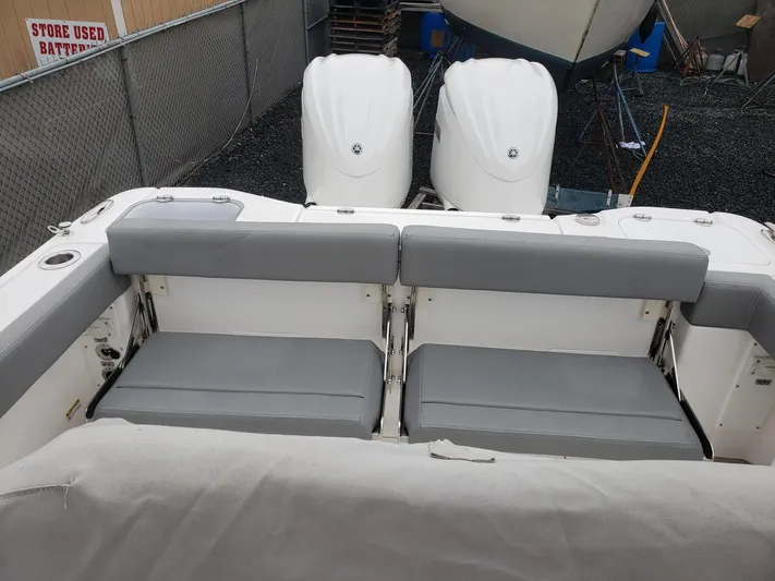  Yacht Photos Pics 2023 Everglades 285CC boat with dual engines and gray seating in a storage area.