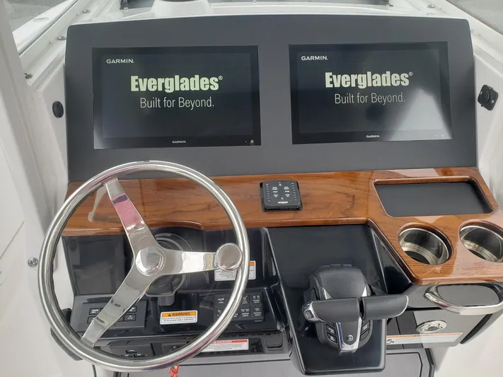  Yacht Photos Pics 2023 Everglades 285CC boat dashboard with dual Garmin displays and steering wheel.