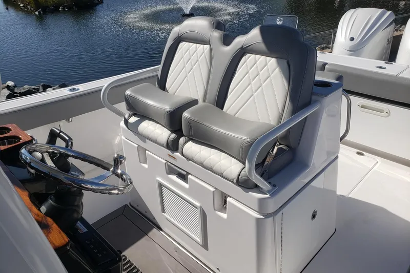  Yacht Photos Pics 2023 Everglades 285CC boat helm with dual gray leather seats and steering wheel.