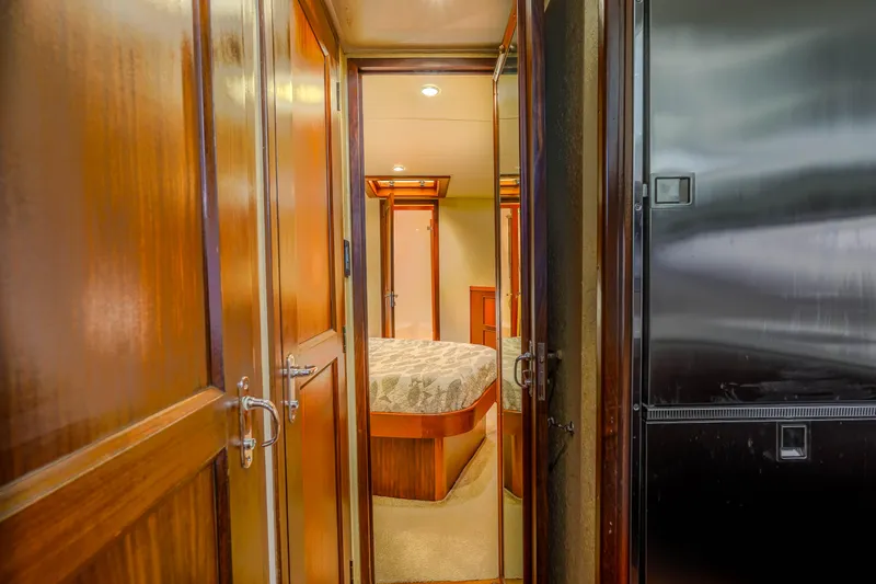 Julia G Yacht Photos Pics Interior of 1982 Hatteras 46 Convertible yacht, featuring wood paneling and cozy bedroom.