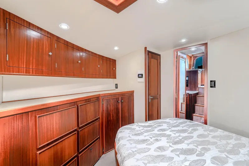 Julia G Yacht Photos Pics Luxurious cabin interior of 1982 Hatteras 46 Convertible yacht with wooden cabinetry.