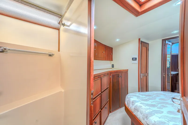 Julia G Yacht Photos Pics Interior of 1982 Hatteras 46 Convertible yacht with wood cabinetry and cozy sleeping area.