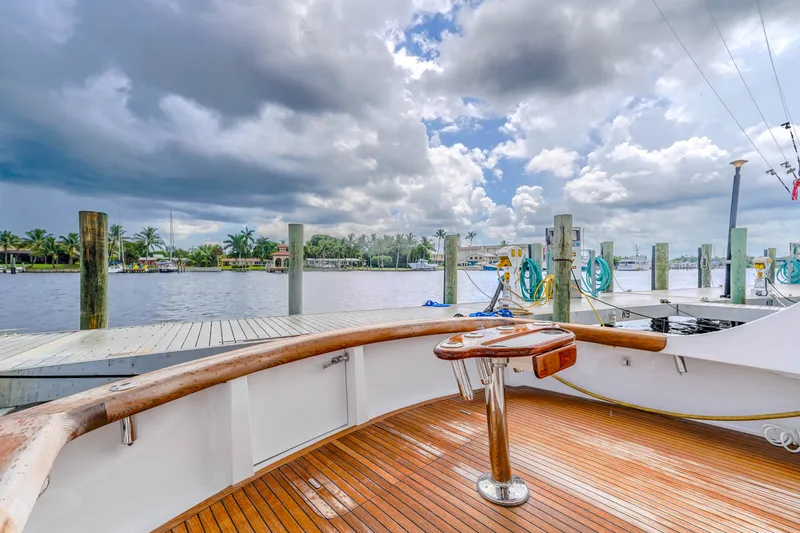 Julia G Yacht Photos Pics 1982 Hatteras 46 Convertible yacht docked under cloudy skies.
