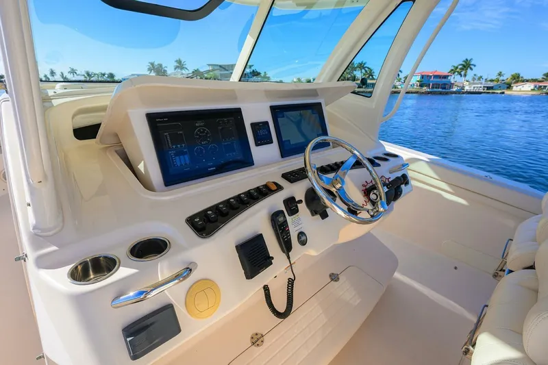  Yacht Photos Pics 2018 Grady-White Canyon 376 helm with modern controls and scenic waterfront view.