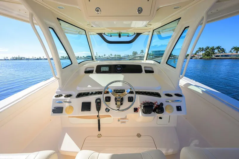  Yacht Photos Pics 2018 Grady-White Canyon 376 boat helm with steering wheel, controls, and ocean view.