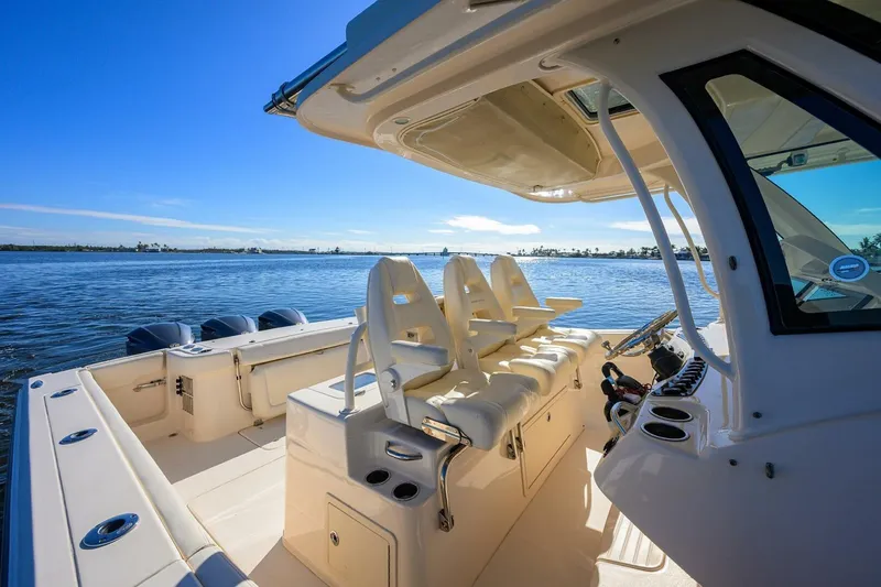  Yacht Photos Pics 2018 Grady-White Canyon 376 boat interior with ocean view, featuring seating and helm.