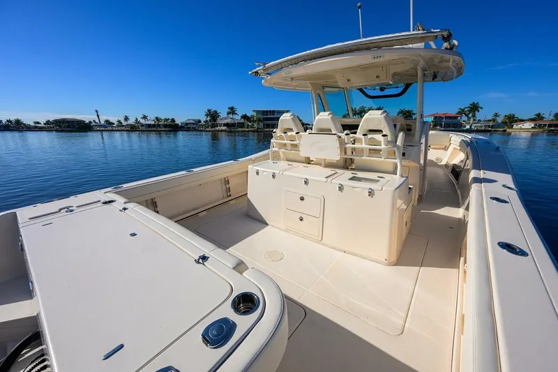  Yacht Photos Pics 2018 Grady-White Canyon 376 boat on calm water, showcasing spacious deck and seating.