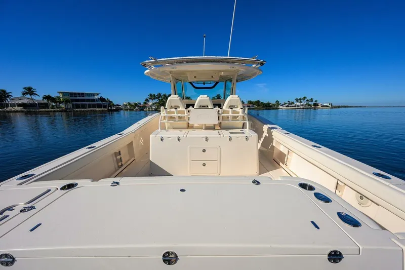 Yacht Photos Pics 2018 Grady-White Canyon 376 boat on calm water, clear blue sky background.