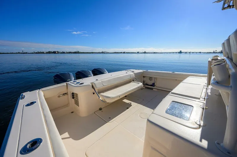  Yacht Photos Pics 2018 Grady-White Canyon 376 boat deck with seating, overlooking calm waters and clear blue sky.