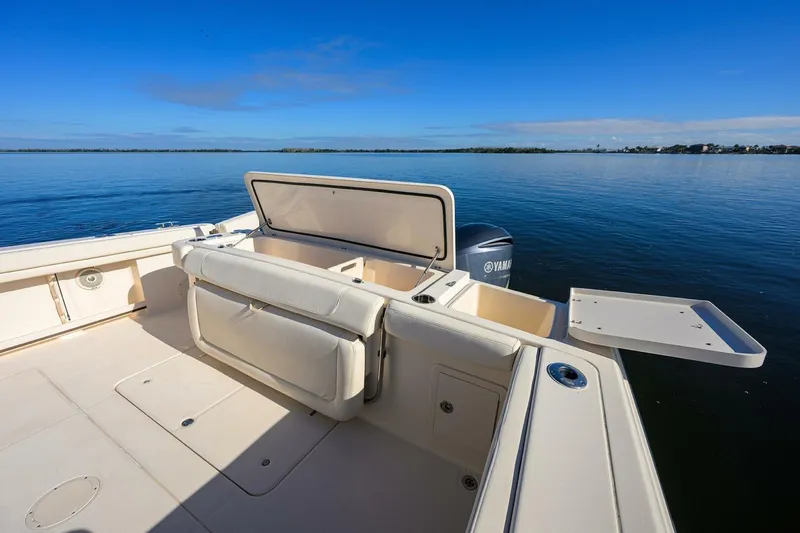  Yacht Photos Pics 2018 Grady-White Canyon 376 boat deck with open storage, on calm water.