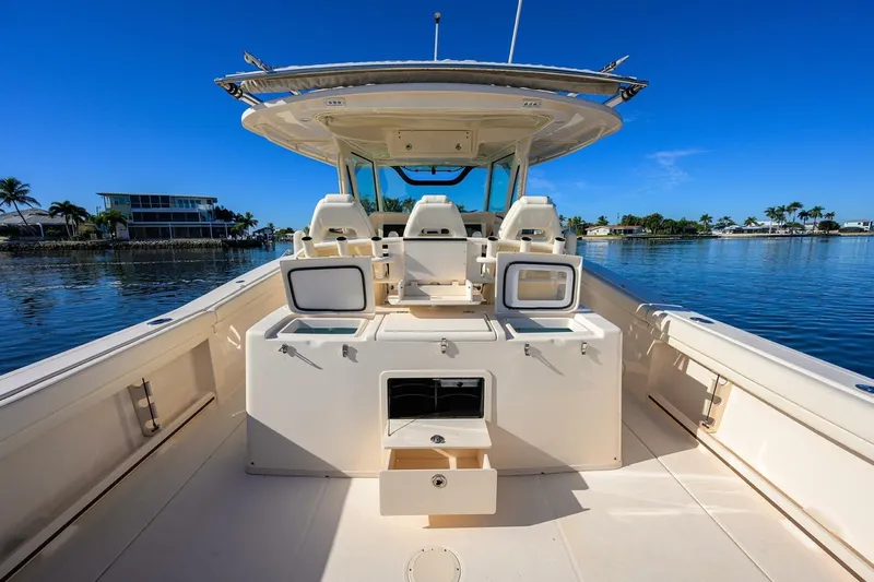  Yacht Photos Pics 2018 Grady-White Canyon 376 boat interior with open storage, on calm water.