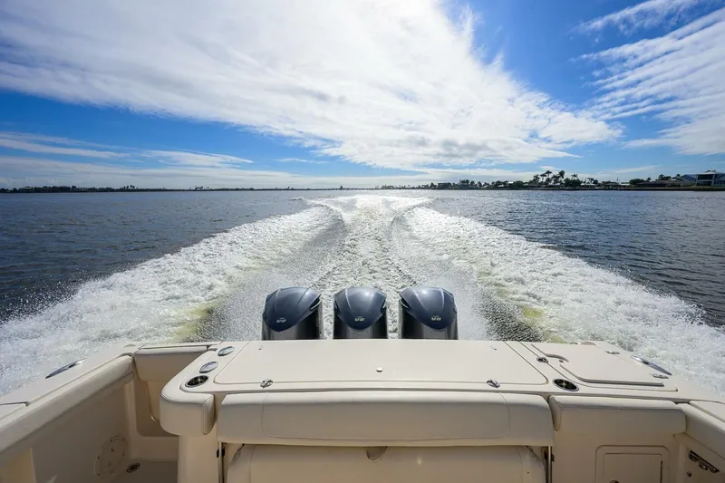  Yacht Photos Pics 2018 Grady-White Canyon 376 boat cruising on open water under a blue sky.