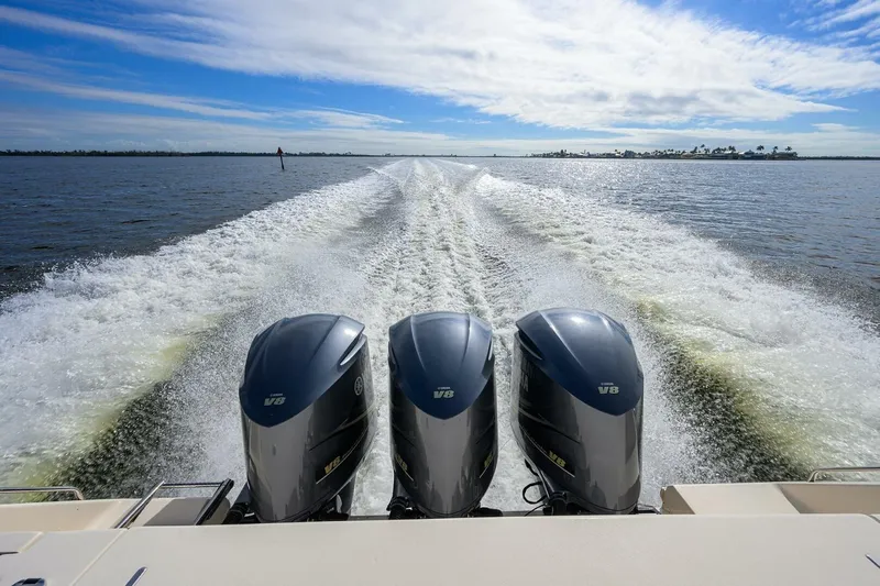  Yacht Photos Pics 2018 Grady-White Canyon 376 boat with triple V8 engines cruising on open water.