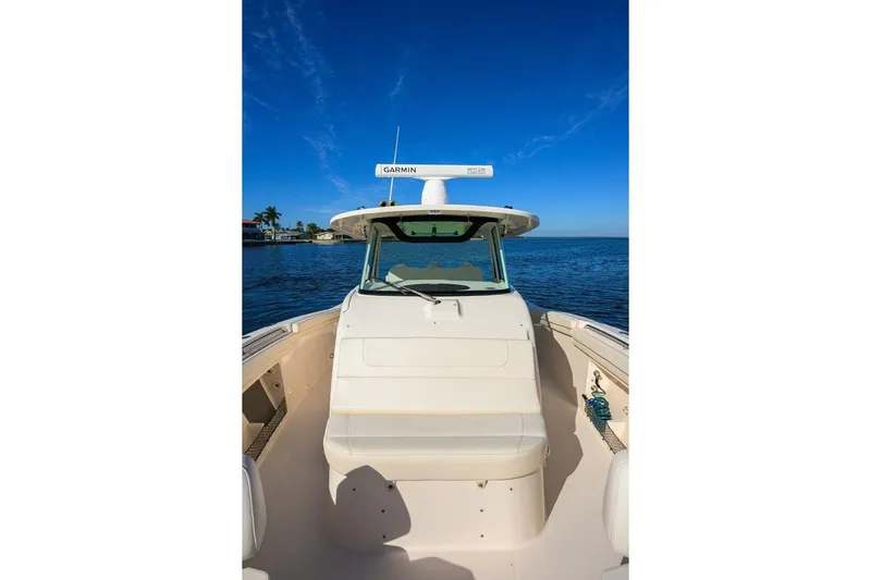  Yacht Photos Pics 2018 Grady-White Canyon 376 boat on calm water under clear blue sky.