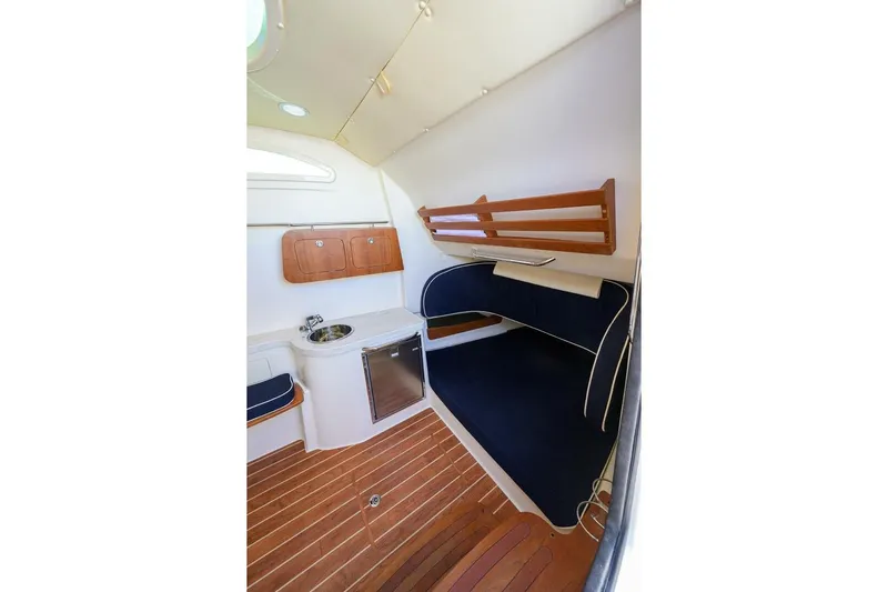 Yacht Photos Pics 2018 Grady-White Canyon 376 cabin interior with seating, sink, and wooden flooring.