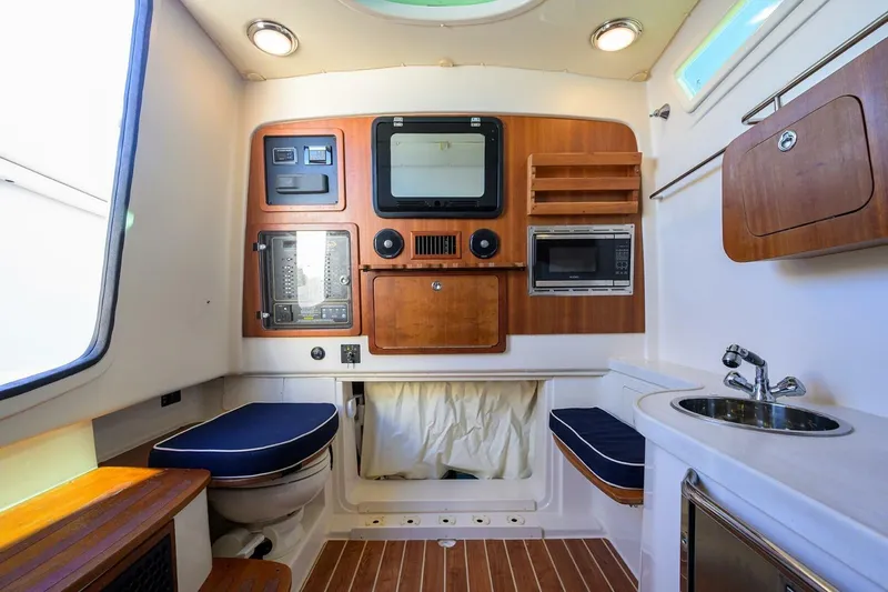  Yacht Photos Pics 2018 Grady-White Canyon 376 cabin interior with kitchenette, seating, and modern amenities.