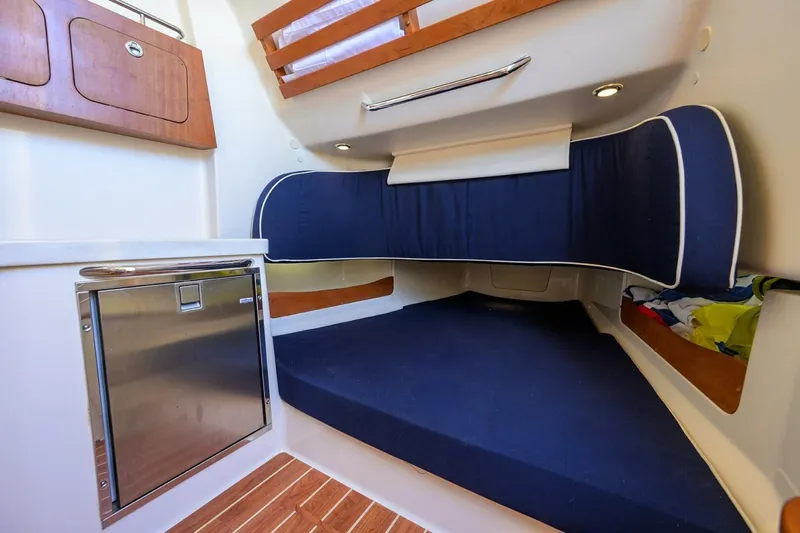  Yacht Photos Pics 2018 Grady-White Canyon 376 cabin interior with blue seating and wooden accents.