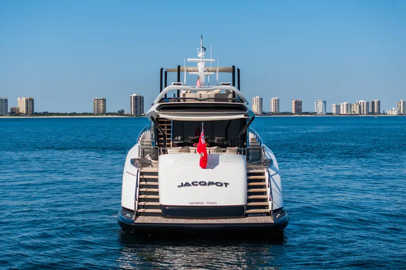  Yacht Photos Pics Mangusta 104 REV 2023 yacht on water with city skyline in background.