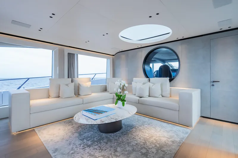  Yacht Photos Pics Luxurious interior of 2023 Mangusta 104 REV yacht with elegant seating and modern decor.