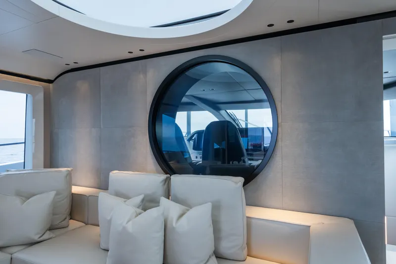  Yacht Photos Pics Luxurious interior of 2023 Mangusta 104 REV yacht with modern design and plush seating.