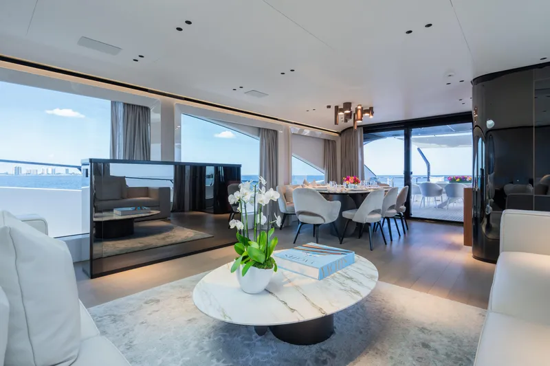  Yacht Photos Pics Luxurious interior of 2023 Mangusta 104 REV yacht with elegant dining area and panoramic views.