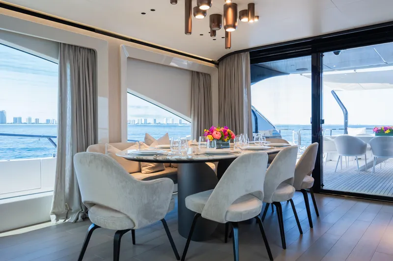  Yacht Photos Pics Luxurious dining area on 2023 Mangusta 104 REV yacht with ocean view.
