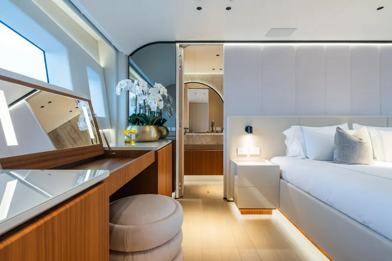  Yacht Photos Pics Luxurious bedroom interior of 2023 Mangusta 104 REV yacht with elegant decor and modern furnishings.