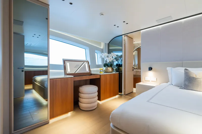  Yacht Photos Pics Luxurious interior of 2023 Mangusta 104 REV yacht bedroom with modern design and elegant furnishings.