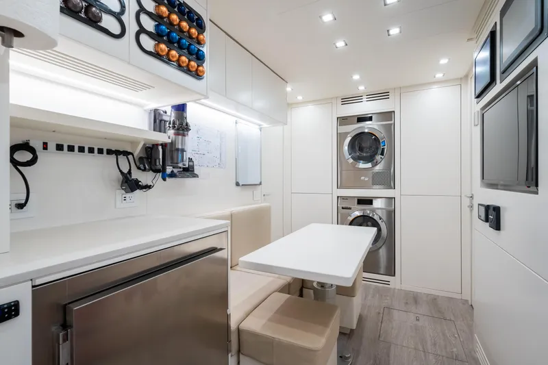  Yacht Photos Pics Luxurious interior of 2023 Mangusta 104 REV yacht with modern amenities and sleek design.