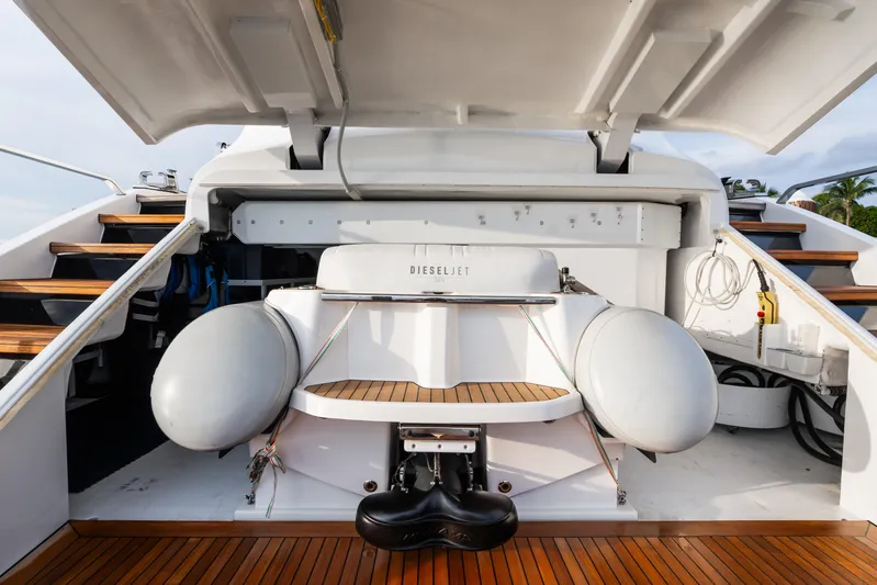  Yacht Photos Pics 2023 Mangusta 104 REV yacht stern with open hatch and wooden deck.