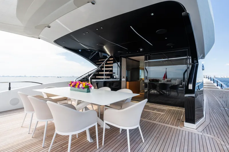  Yacht Photos Pics Luxurious deck of 2023 Mangusta 104 REV yacht with elegant dining area.