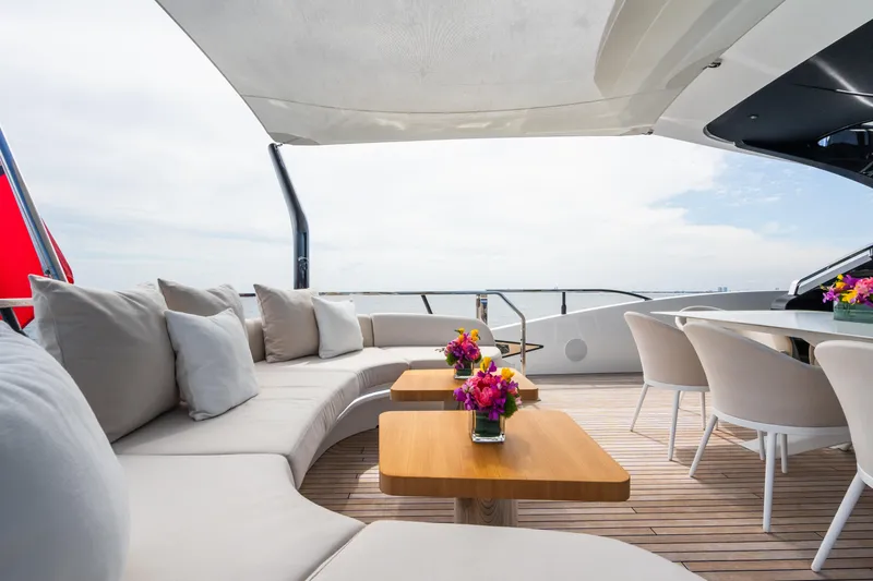  Yacht Photos Pics Luxurious 2023 Mangusta 104 REV yacht deck with elegant seating and floral decor.