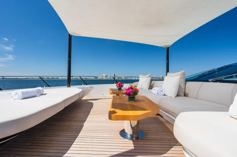  Yacht Photos Pics Luxurious deck of 2023 Mangusta 104 REV yacht with seating and ocean view.
