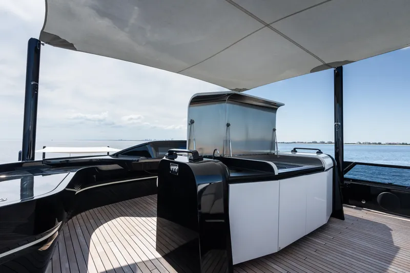  Yacht Photos Pics Luxury deck of 2023 Mangusta 104 REV yacht with sleek design and ocean view.