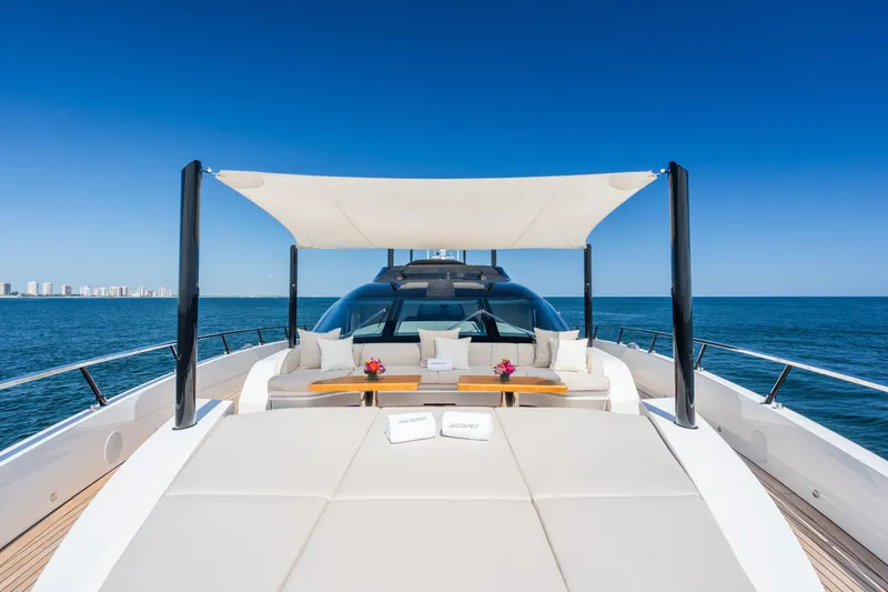  Yacht Photos Pics Luxurious 2023 Mangusta 104 REV yacht deck with sunshade and ocean view.