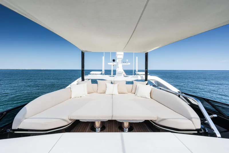 Yacht Photos Pics Luxurious 2023 Mangusta 104 REV yacht deck with elegant seating and ocean view.