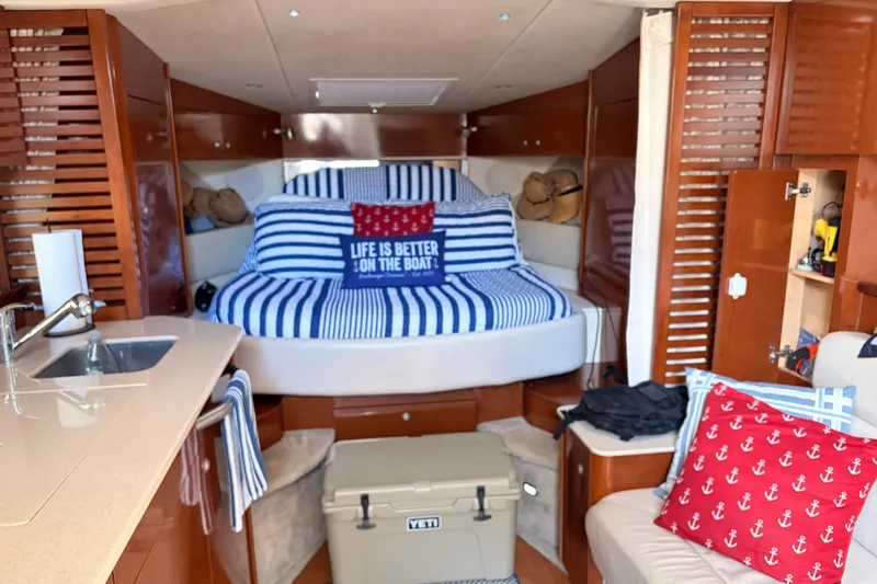 Yacht Photos Pics 2008 Sea Ray Sundancer 350 cabin interior with striped bedding and nautical decor.