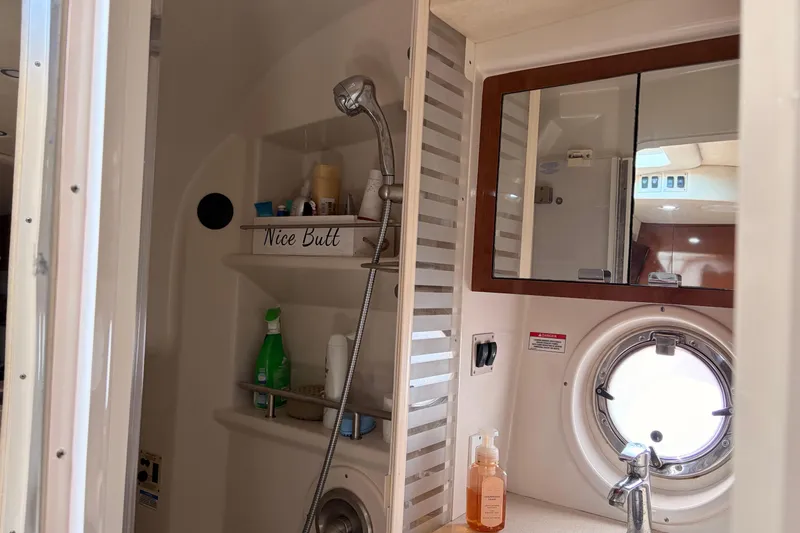  Yacht Photos Pics Bathroom interior of 2008 Sea Ray Sundancer 350 yacht with shower and porthole window.