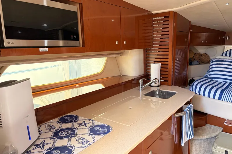  Yacht Photos Pics Interior of 2008 Sea Ray Sundancer 350 yacht with kitchenette and cozy sleeping area.