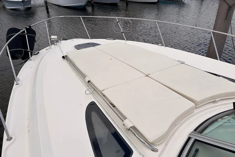  Yacht Photos Pics 2008 Sea Ray Sundancer 350 yacht with sun pads on deck, docked at marina.