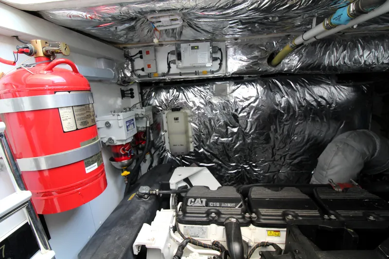  Yacht Photos Pics Engine room of 2013 Princess V62 yacht with CAT engine and fire extinguisher.