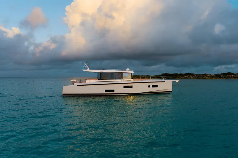  Yacht Photos Pics 2026 Omikron Yachts OT-60 sailing on calm waters under a cloudy sky.
