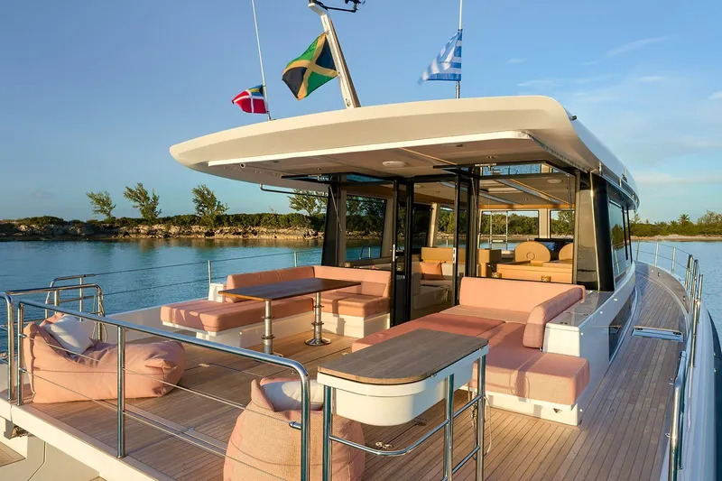  Yacht Photos Pics Luxurious 2026 Omikron Yachts OT-60 with elegant deck seating and scenic water view.