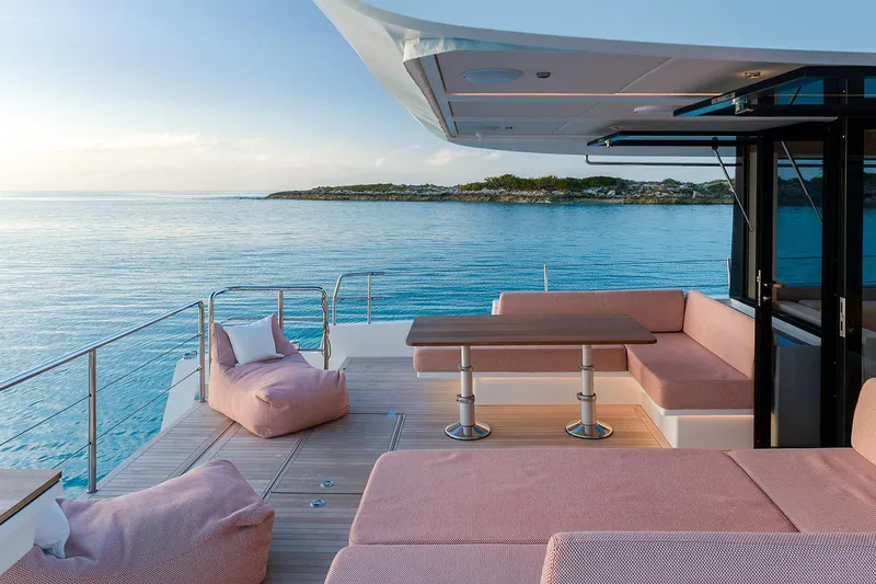  Yacht Photos Pics Luxurious 2026 Omikron Yachts OT-60 deck with elegant seating, overlooking serene ocean view.