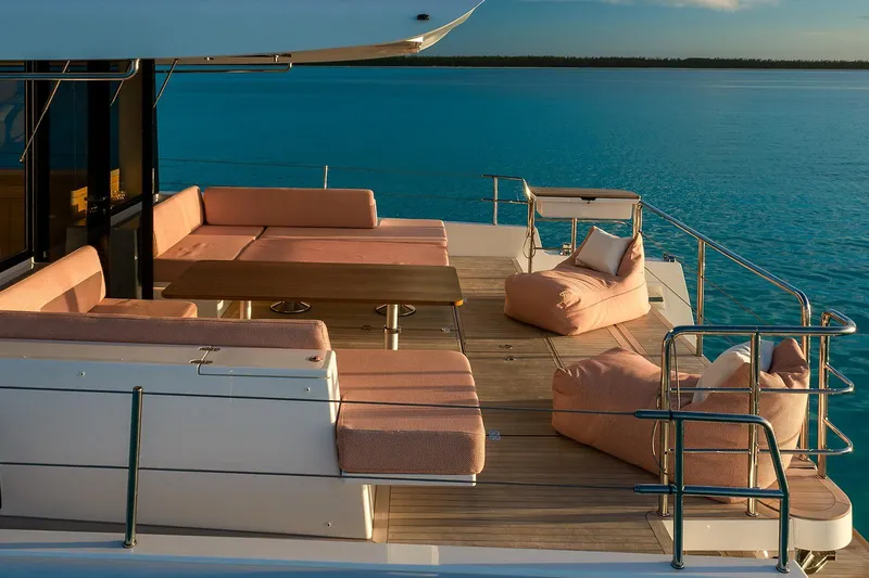  Yacht Photos Pics Luxurious Omikron Yachts OT-60 deck with elegant seating, overlooking serene blue waters, 2026 model.