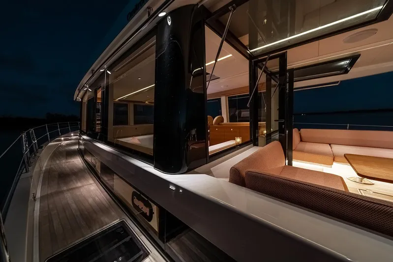  Yacht Photos Pics Luxurious 2026 Omikron Yachts OT-60 interior at night, featuring elegant seating and ambient lighting.