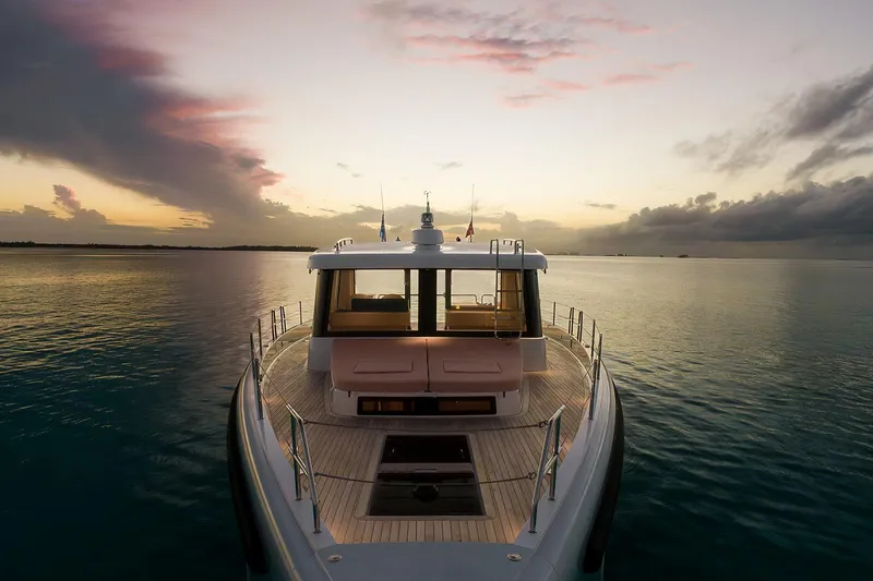  Yacht Photos Pics 2026 Omikron Yachts OT-60 at sunset on calm waters.