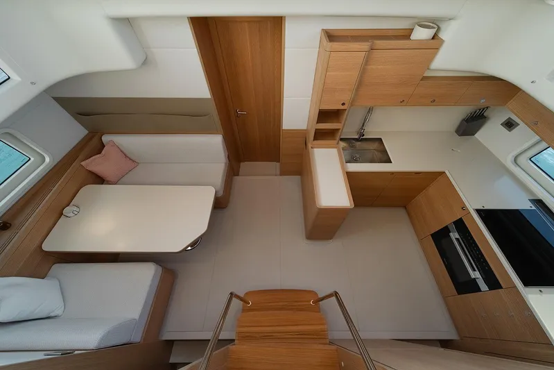  Yacht Photos Pics Modern interior of 2026 Omikron Yachts OT-60, featuring sleek kitchen and dining area.