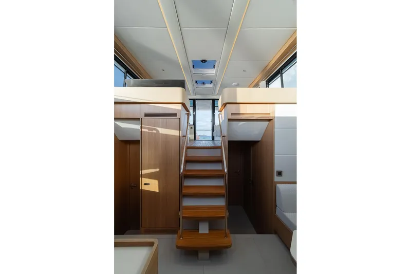  Yacht Photos Pics Interior of 2026 Omikron Yachts OT-60, featuring modern wooden staircase and sleek design.
