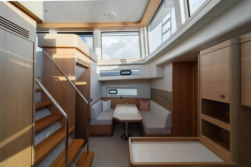  Yacht Photos Pics Luxurious interior of 2026 Omikron Yachts OT-60, featuring modern wood finishes and ample natural light.